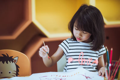 Girl looking away while sitting at home