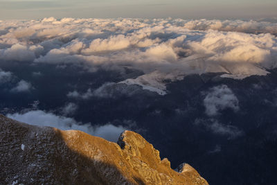 Aerial view of clouds over mountain