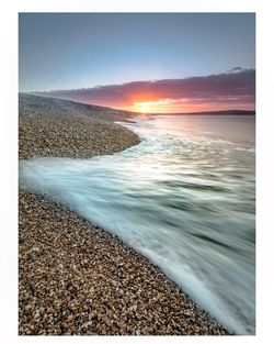 Scenic view of sea against sky at sunset