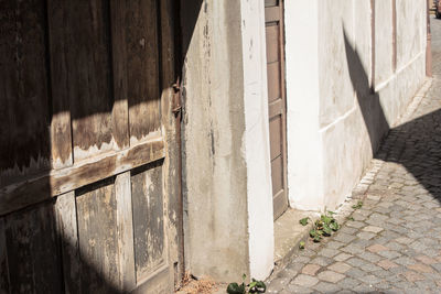 Footpath by stone wall of old building