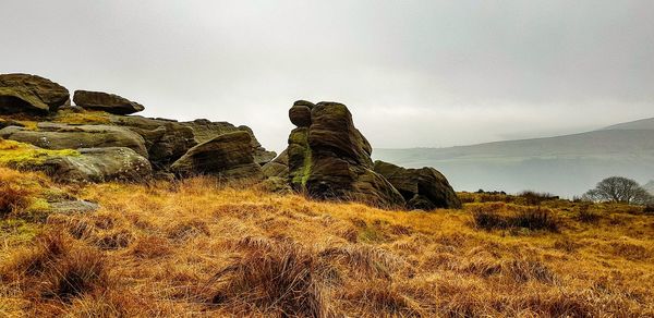 Rock formations on landscape against sky