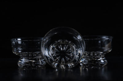 Close-up of glass bowls against black background