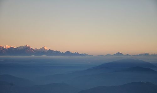 Scenic view of mountains against clear sky during sunset