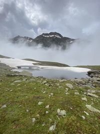 Scenic view of snow covered land against sky