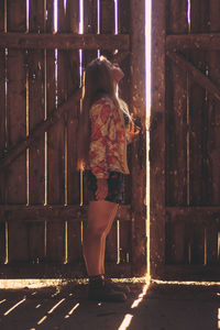 Rear view of woman walking in illuminated city at night