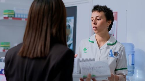 Portrait of female doctor examining patient at clinic