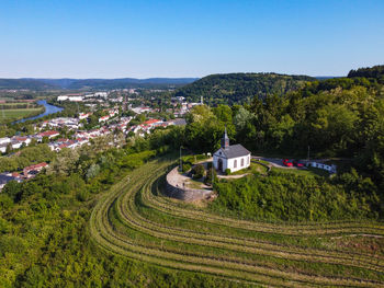 High angle view of agricultural field against buildings in city