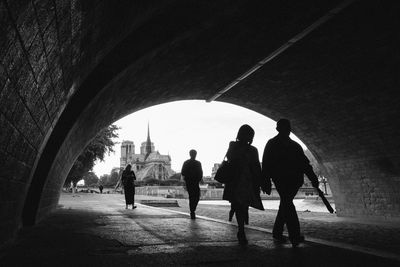Rear view of silhouette people walking in city