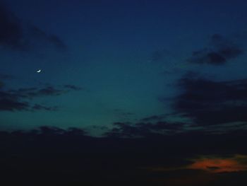 Low angle view of silhouette moon against sky at night