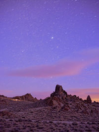 Scenic view of rock formation against sky at night