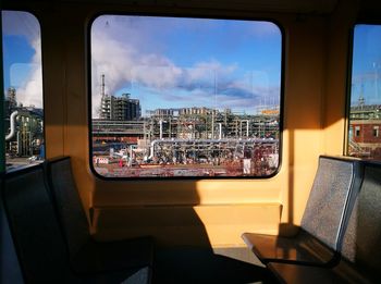 Buildings against sky seen through glass window