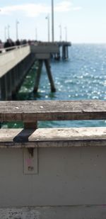 Close-up of pier over sea against sky