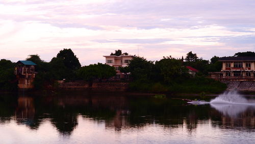 Reflection of trees and buildings in lake