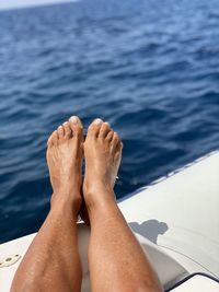 Low section of man relaxing in swimming pool