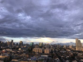 Buildings in city against cloudy sky