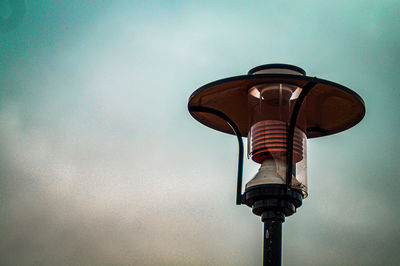 Low angle view of illuminated street light against sky