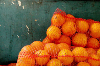 Oranges in nets for sale at market