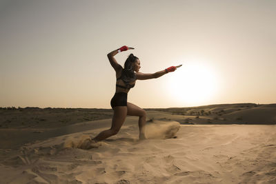 Mixed race woman in desert against clear sky