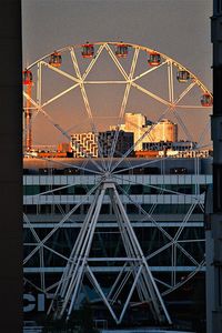 Low angle view of illuminated ferris wheel against sky