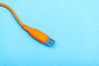 High angle view of usb cable on blue background