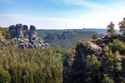 View of rocks on landscape against sky