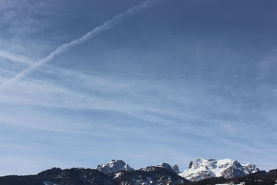 Low angle view of snowcapped mountains against sky