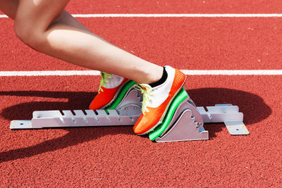 Low section of person wearing red shoes