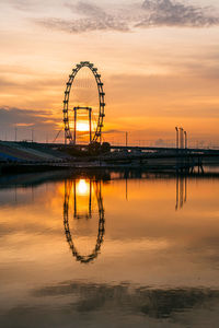 Silhouette ferris wheel against sky at sunset