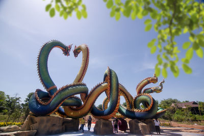  low angle twin stucco painted as a large serpent at pra kai keaw wang nakin, udon thani, thailand. 