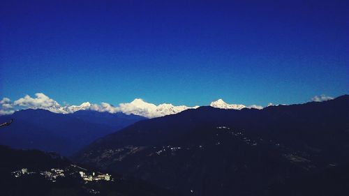 Scenic view of mountains against blue sky