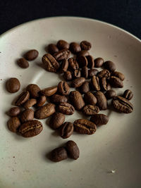 Close-up of roasted coffee beans on table