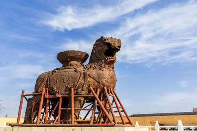 Low angle view of statue against sky