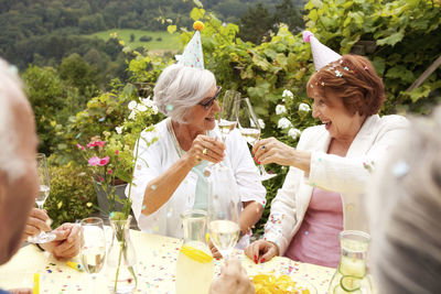 Group of seniors celebrating, drinking champagne