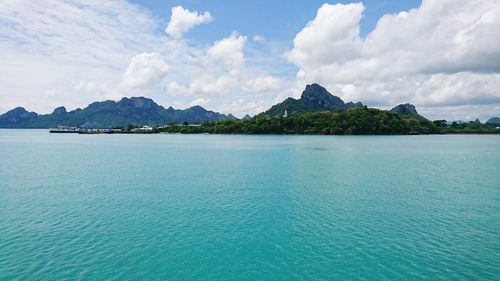 Panoramic view of sea and mountains against sky