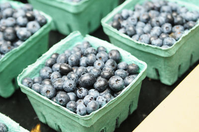 High angle view of blueberries in containers for sale at market