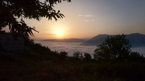 Scenic view of silhouette mountains against sky at sunset