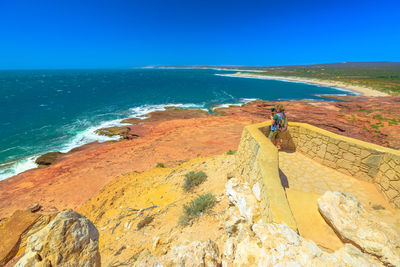 Man by sea at kalbarri national park on sunny day