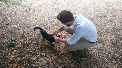 High angle view of man with cat