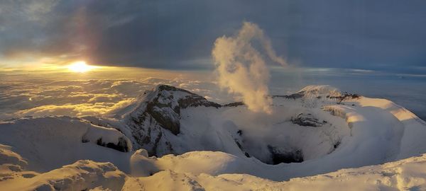 Panoramic view of snow covered landscape against sky