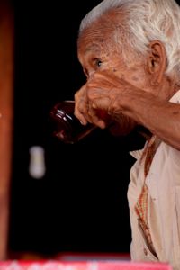 Close-up portrait of a man drinking glass