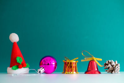 Close-up of christmas decorations on table against blue background
