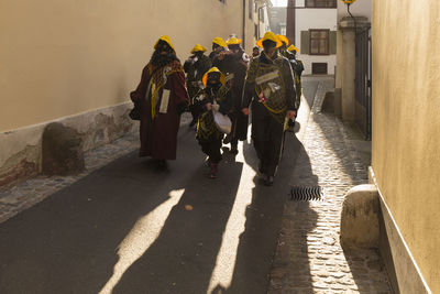 Basel carnival. basel, switzerland. feb 21st, 18. carnival group in dark costumes in the old town
