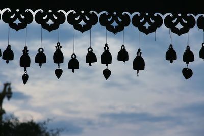 Close-up of cross hanging against sky