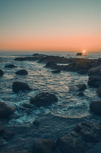 Scenic view of sea against clear sky during sunset