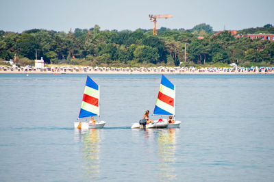 People enjoying in sailboat at sea