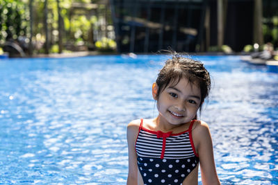 Portrait of girl by swimming pool
