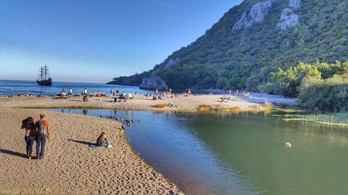 People on beach against sky