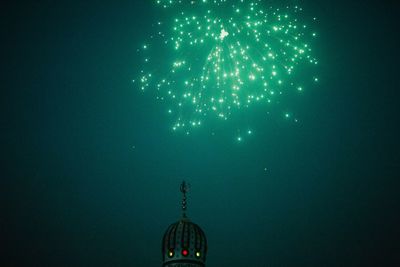 Low angle view of illuminated lights against sky at night