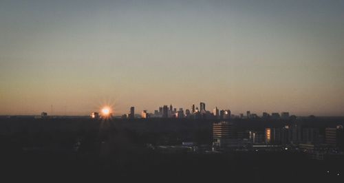 City against sky during sunset