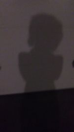 Close-up of silhouette hand on shadow